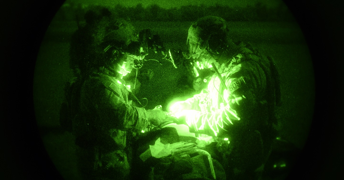 Soldiers  performing medical exercise at night.